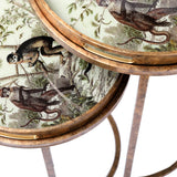 Antique brass tables with jungle monkey illustrations on round trays.