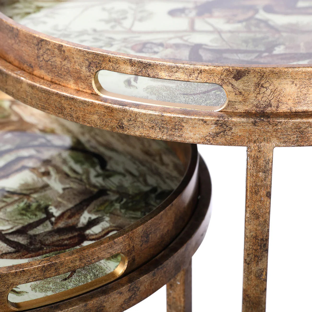 Bronze-finished tray tables with jungle-themed surface design.