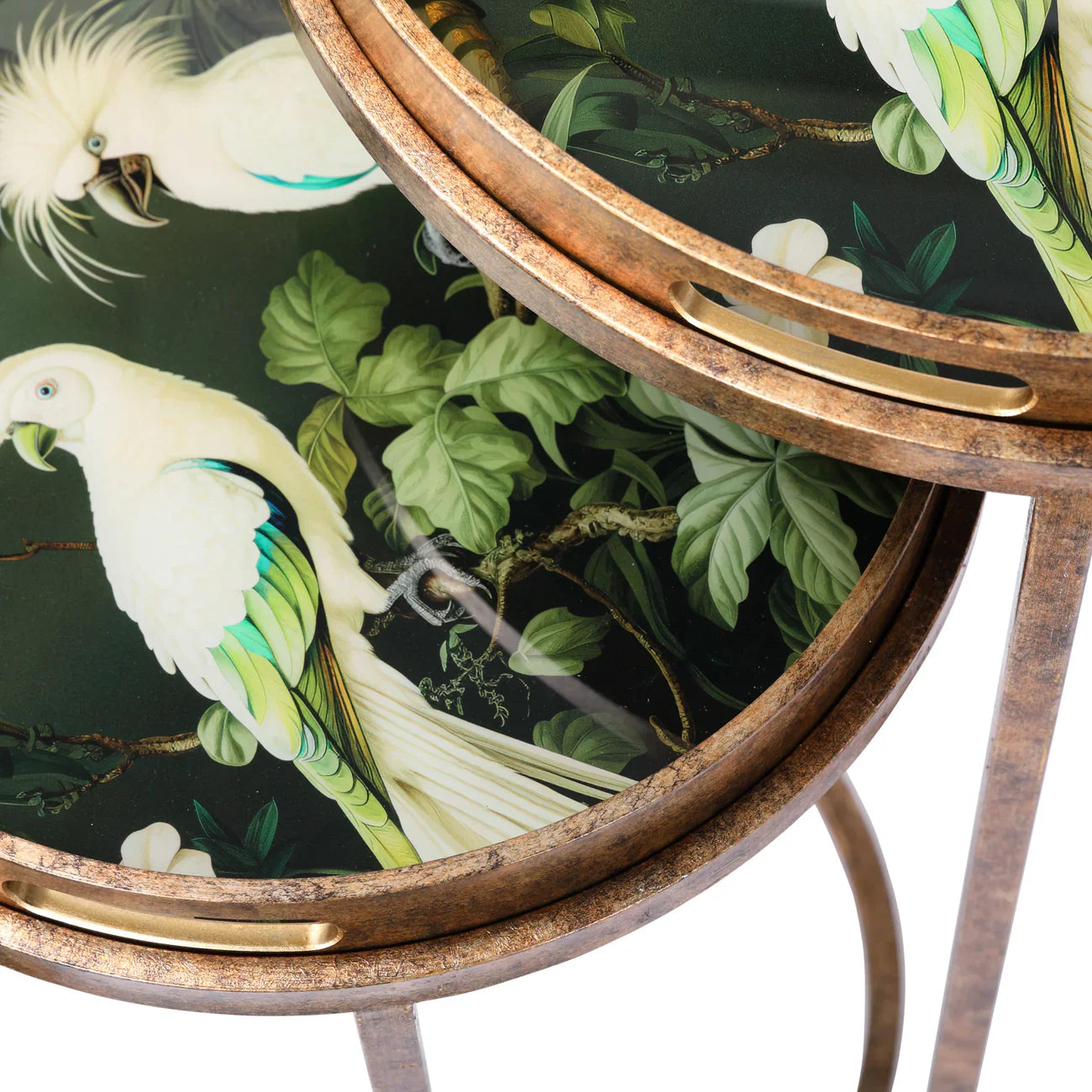 Close-up of round tray tables with tropical bird and leaf design.