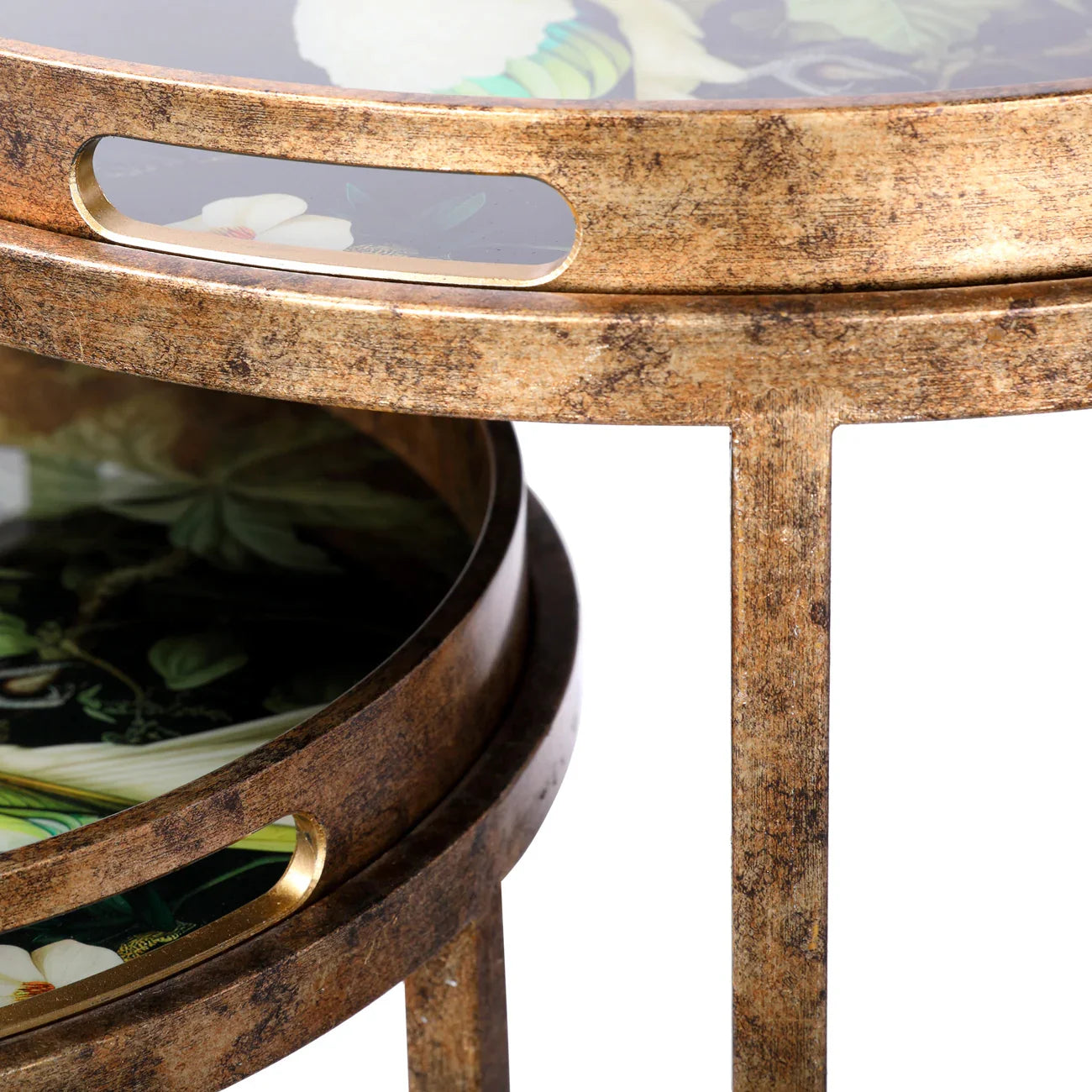 Aged gold side tables with tropical floral pattern and cut-out handles.