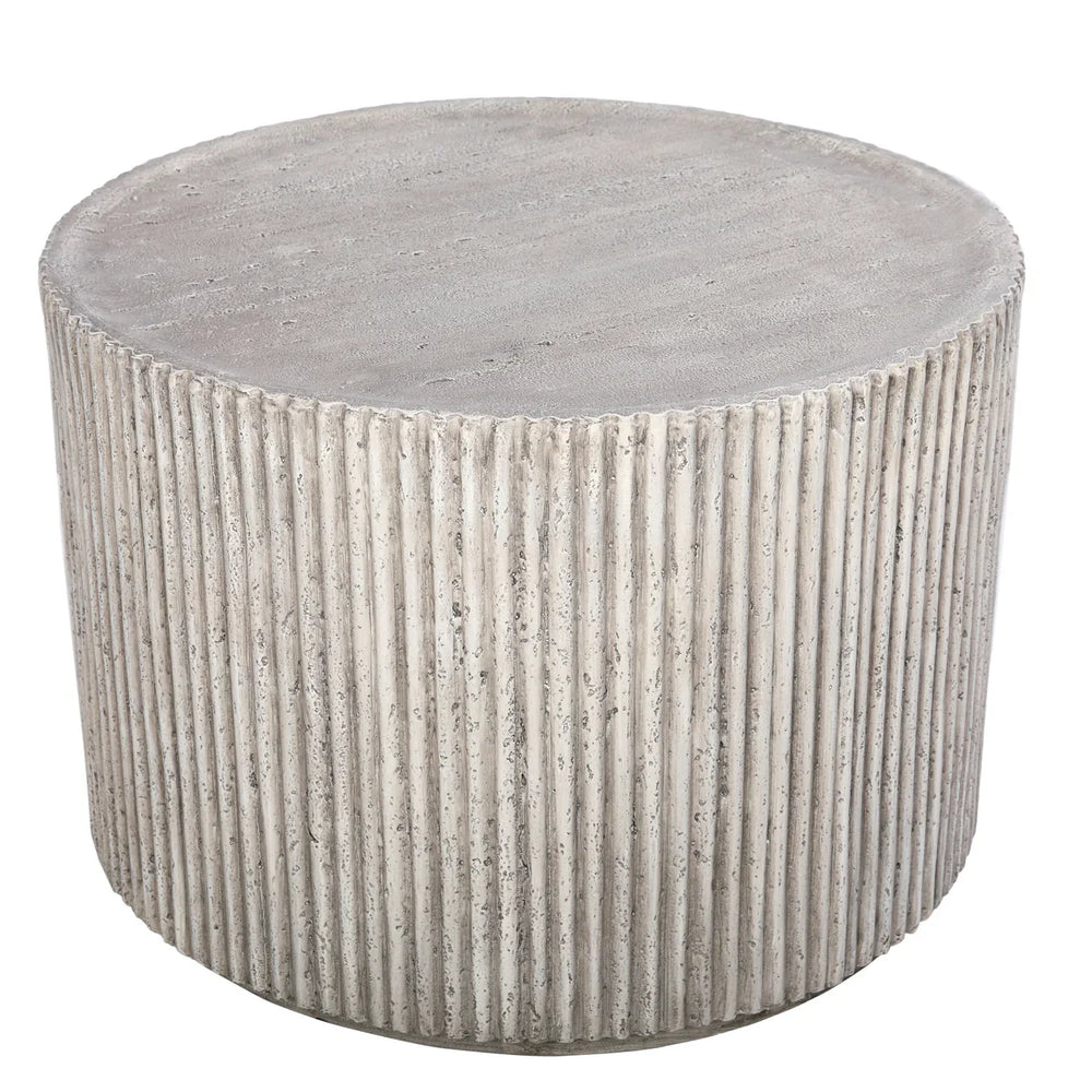 Round concrete table with ribbed texture and smooth top surface.