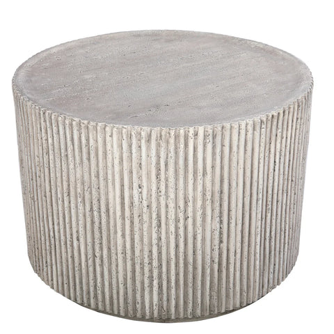 Round concrete table with ribbed texture and smooth top surface.