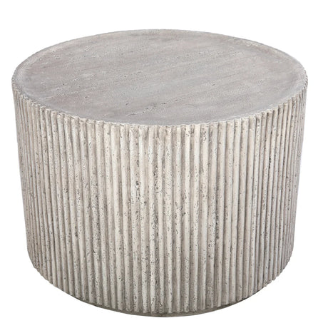 Round concrete table with ribbed texture and smooth top surface.