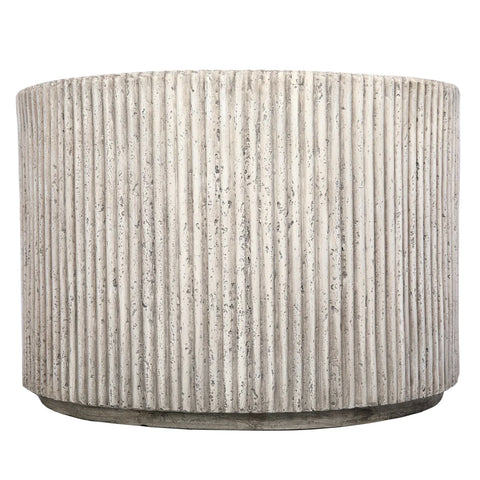 Beige cylindrical table with vertical ribbed texture.