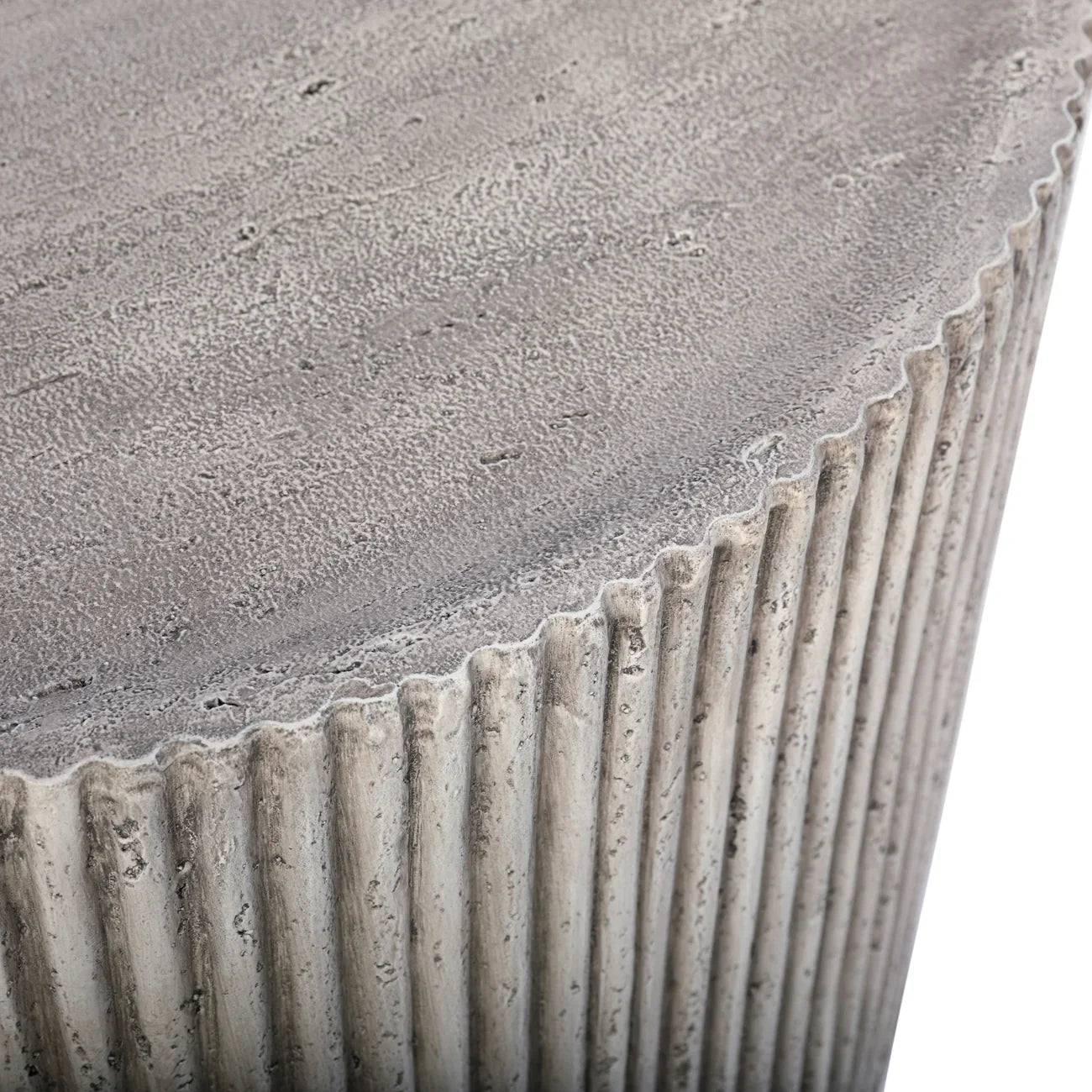 Ribbed grey concrete table edge with textured surface detail.