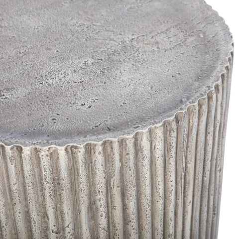 Textured grey surface with ribbed detailing on the side table.