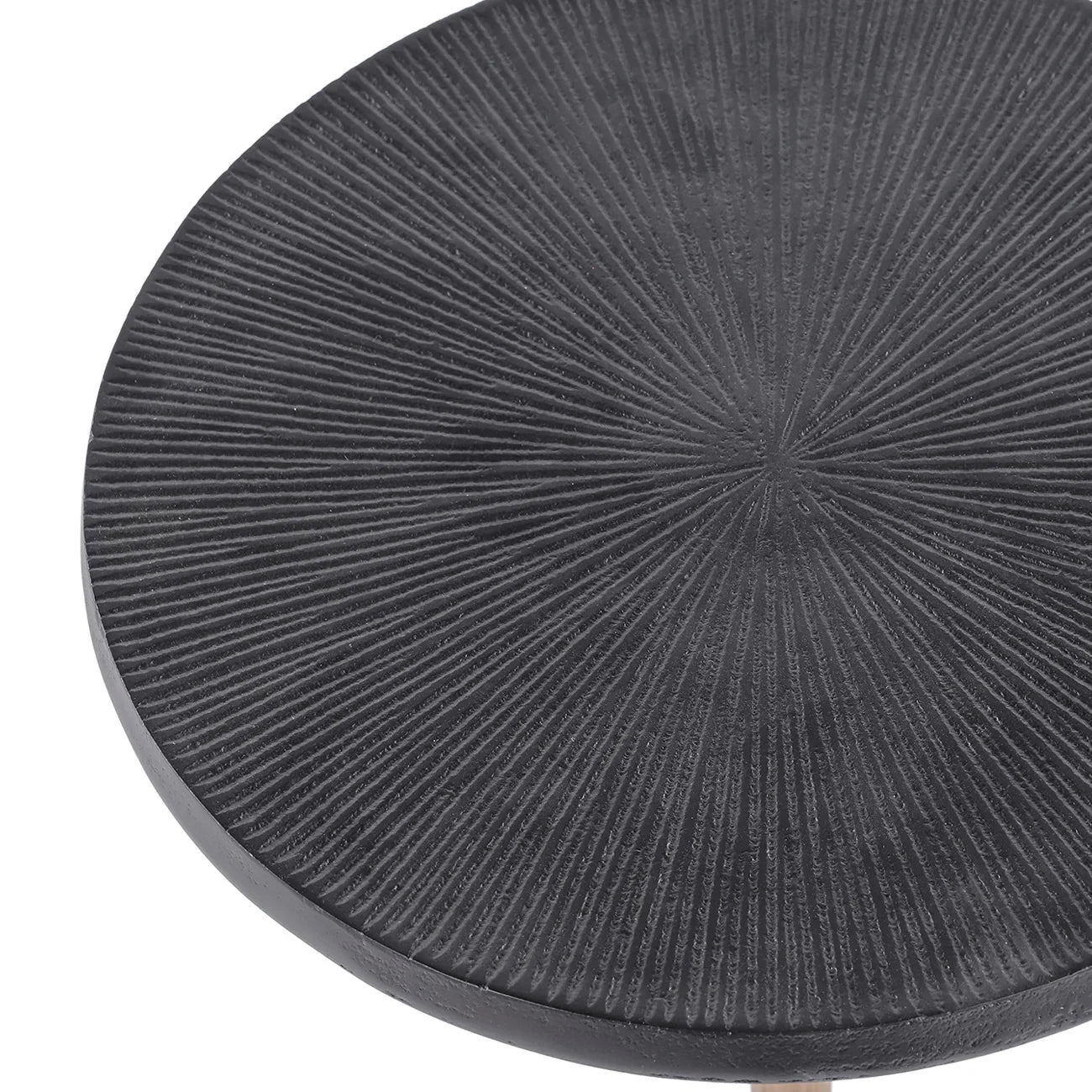 Black round table surface with radial textured pattern