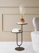 White marble accent table with vase and book in a cozy room setting.