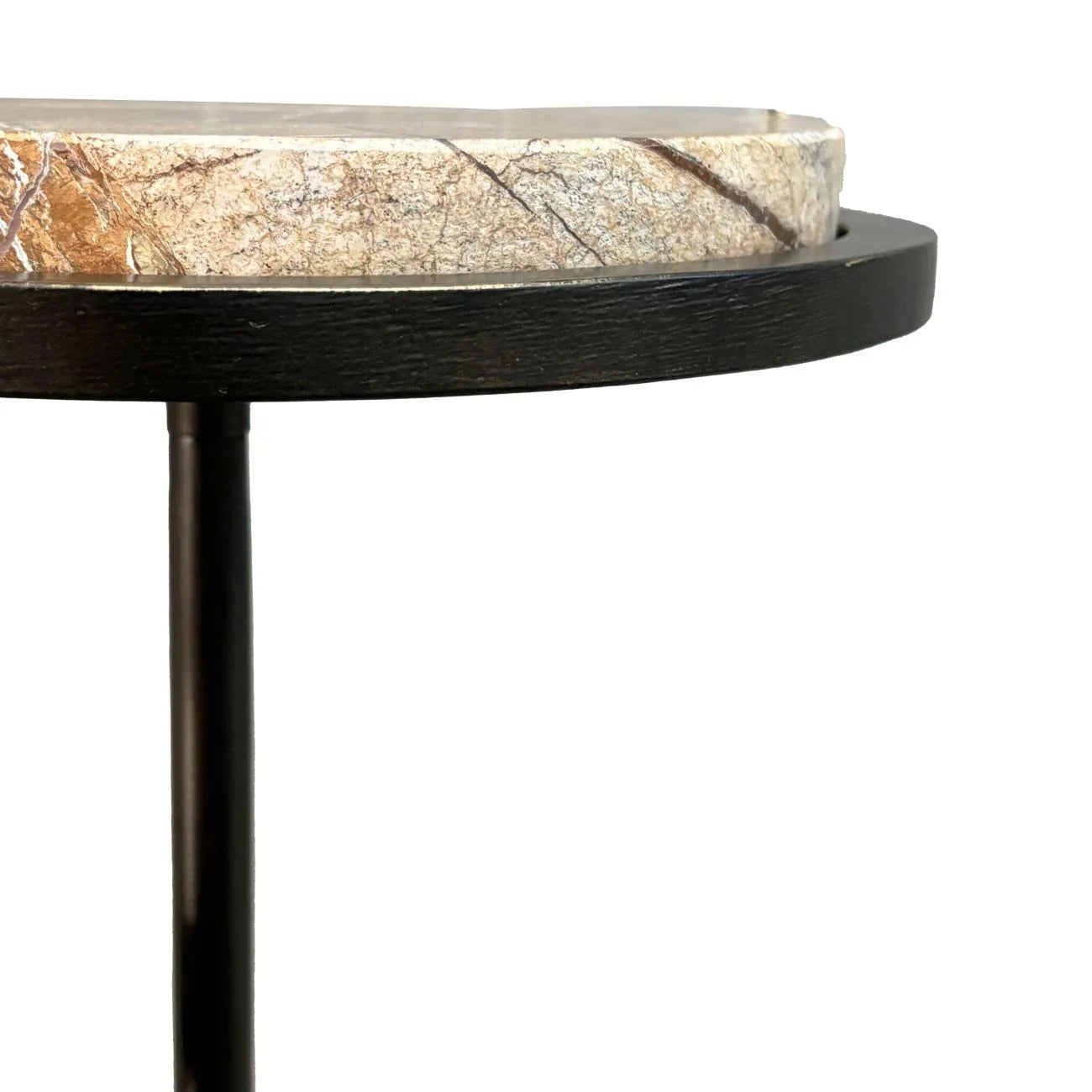 Close-up of round table edge with marble top and black base.