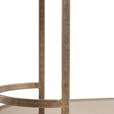 Aged gold trolley frame with textured metal finish.
