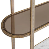 Aged gold shelving unit with oval glass shelf detail.