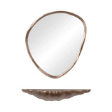 Curved brass shelf with matching abstract mirror above.
