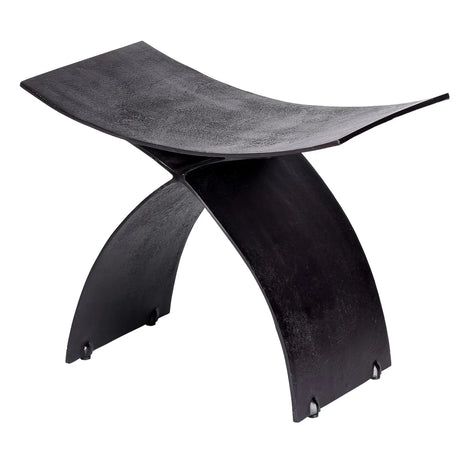 Black iron stool with curved seat and crossed legs.