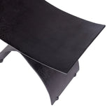 Curved black iron stool seat with textured surface detail.