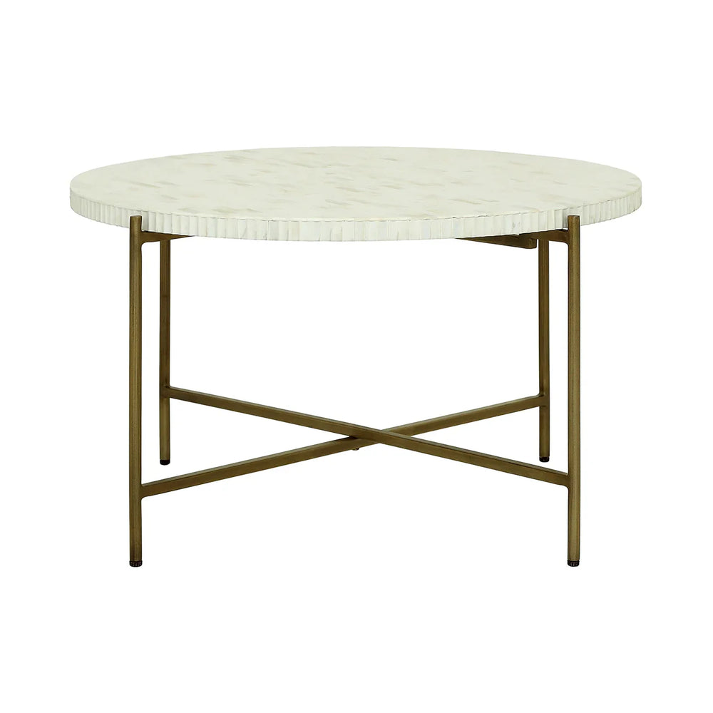 Round bone inlay table with brass legs and intricate surface pattern.