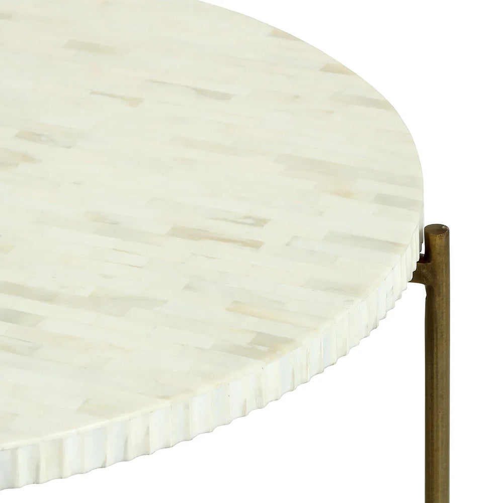 Round table with ivory inlay and brass legs detail.