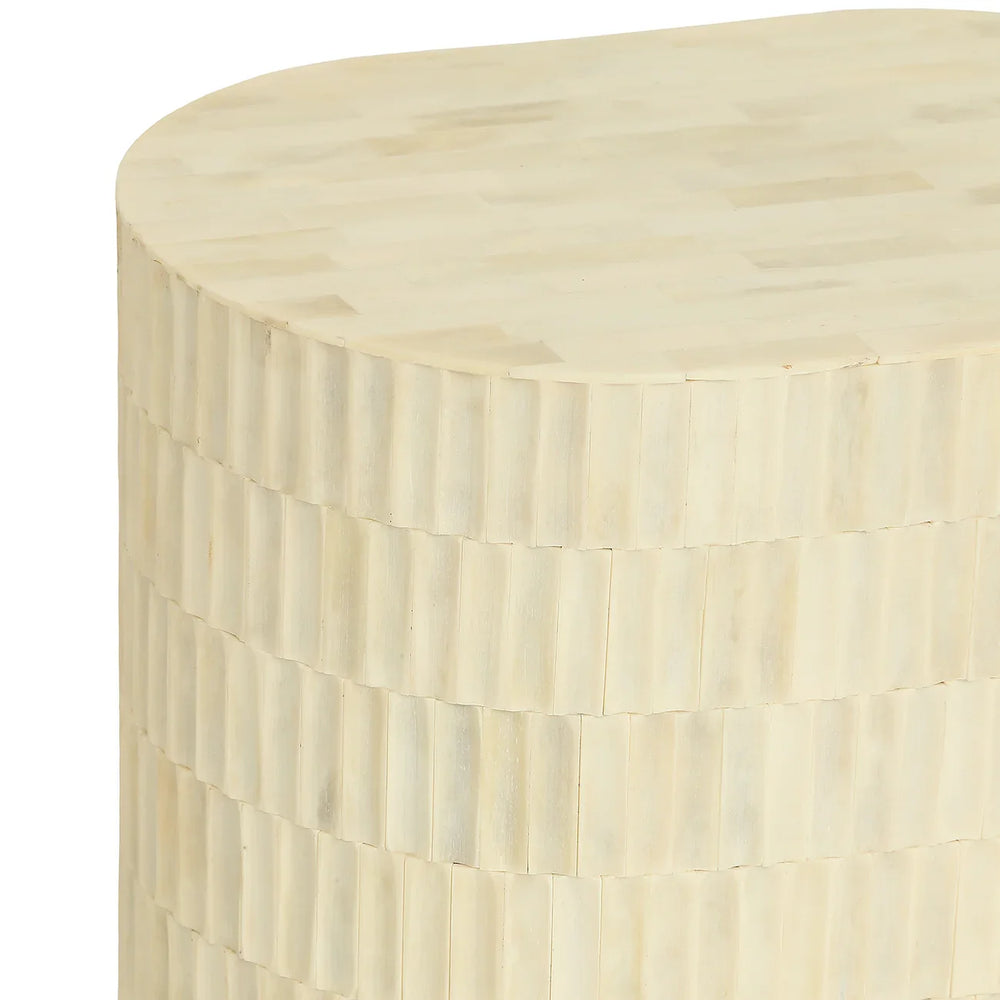 Cream side table with intricate bone inlay pattern.