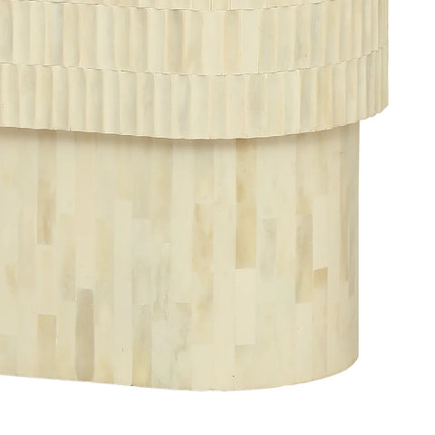 Cream side table with intricate bone inlay pattern and curved edges.