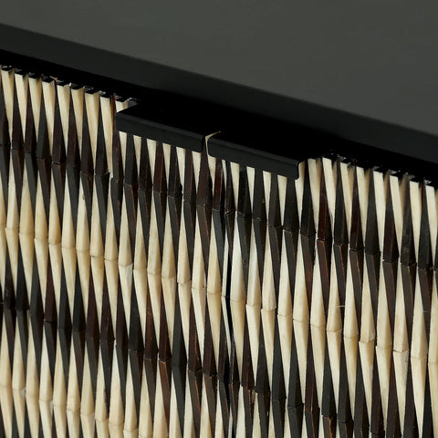 Black and ivory sideboard detail with geometric inlay pattern.