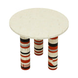 Round bone inlay table with vibrant patterned legs in red, black, and white.