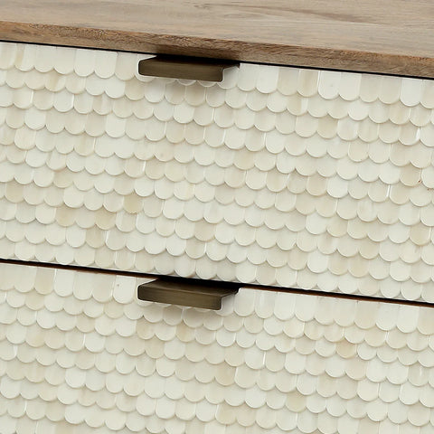 Cream scalloped inlay detail on drawer front with metal handles.