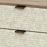 Cream scalloped inlay detail on drawer front with metal handles.