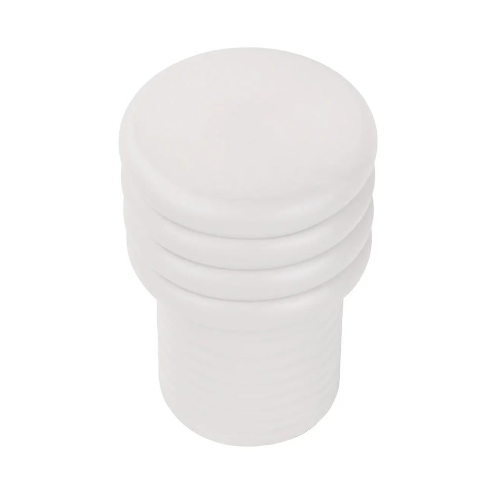 White round side table with stacked, ribbed design.
