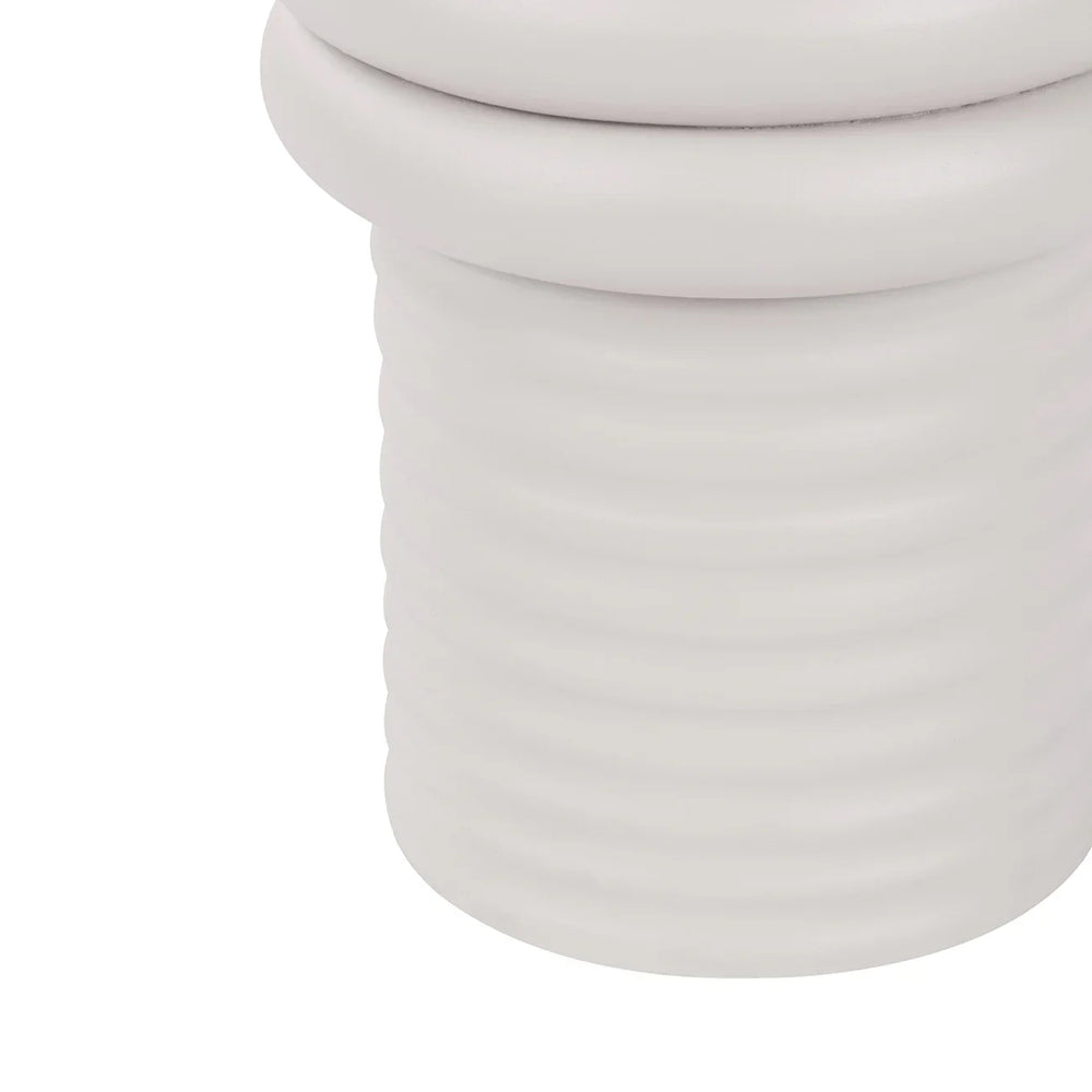 White ribbed base of a side table with smooth curves