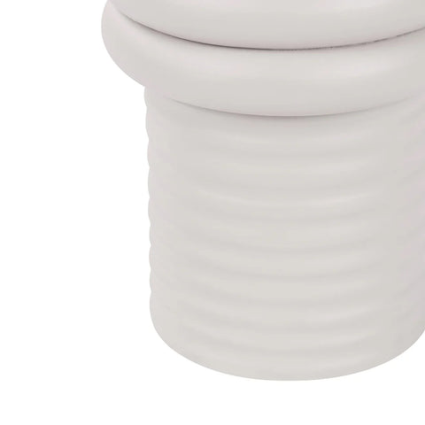 White ribbed base of a side table with smooth curves