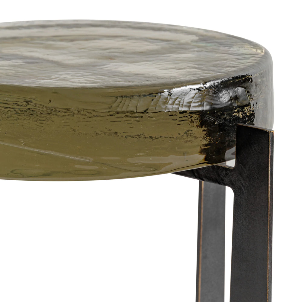 Olive green glass tabletop with textured surface and metal leg detail.