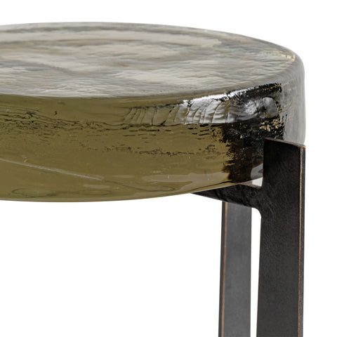 Olive green glass tabletop with textured surface and metal leg detail.