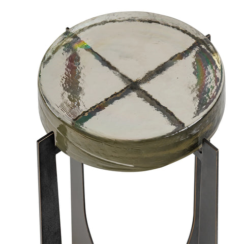 Round glass table top with textured surface and metal legs.