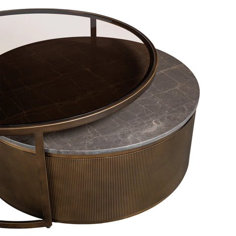 Bronze nesting tables with marble and glass tops, showcasing elegant textures.