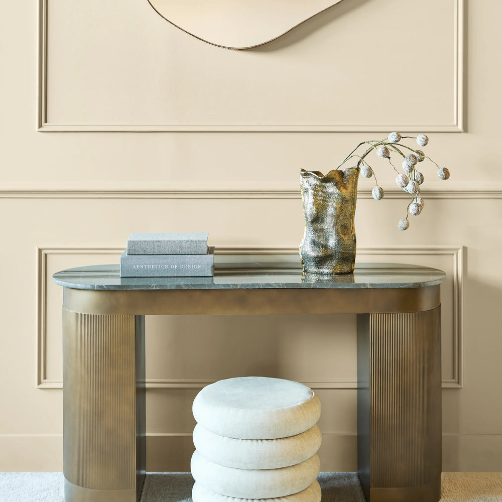Elegant gold study desk with decorative vase and books in a sophisticated setting.