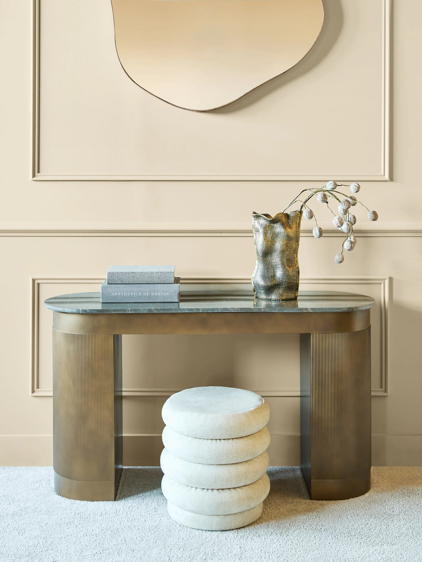 Elegant gold study desk with decorative vase and books in a sophisticated setting.