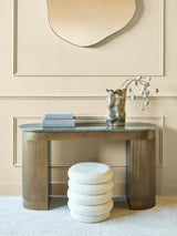 Elegant gold study desk with decorative vase and books in a sophisticated setting.