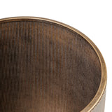 Bronze-toned shelving detail with vertical ribbed texture.