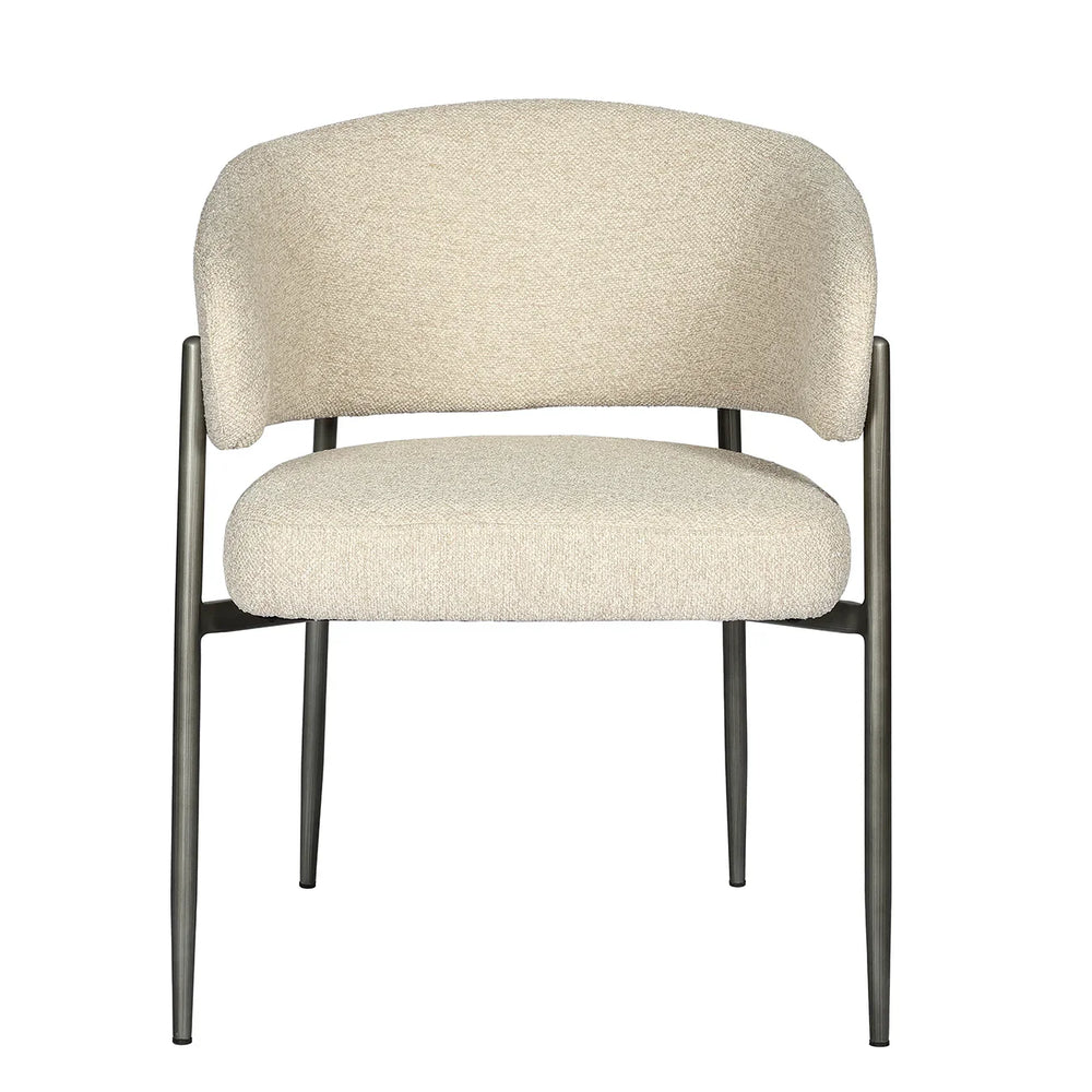 Cream boucle dining chair with curved backrest and metal legs.