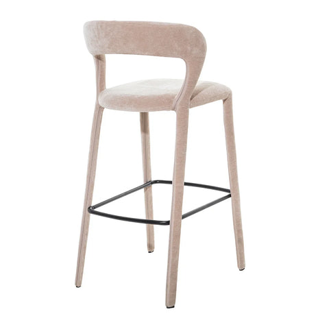 Taupe upholstered bar stool with curved backrest and black footrest.