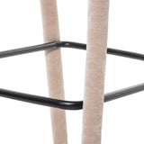 Taupe upholstered stool legs with black metal footrest detail.