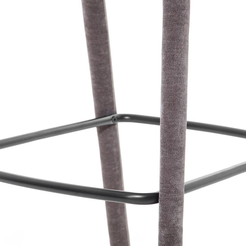 Grey fabric stool leg with black metal footrest detail.