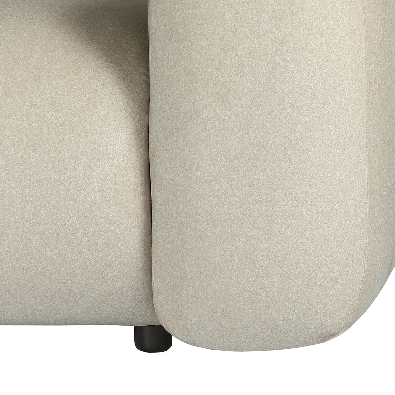 Warm stone velvet sofa arm detail with subtle texture.