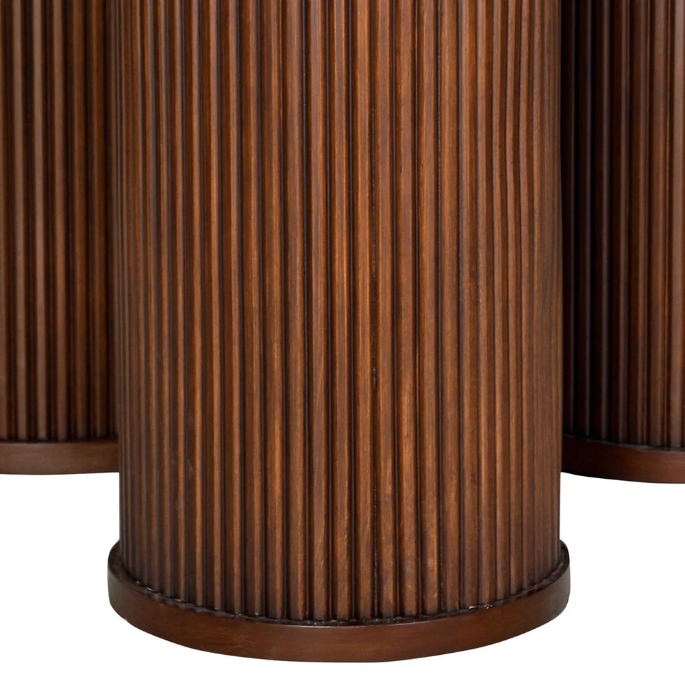Dark wood table base with vertical ribbed texture.