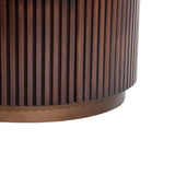 Dark wood chest with vertical grooved texture and rounded base.