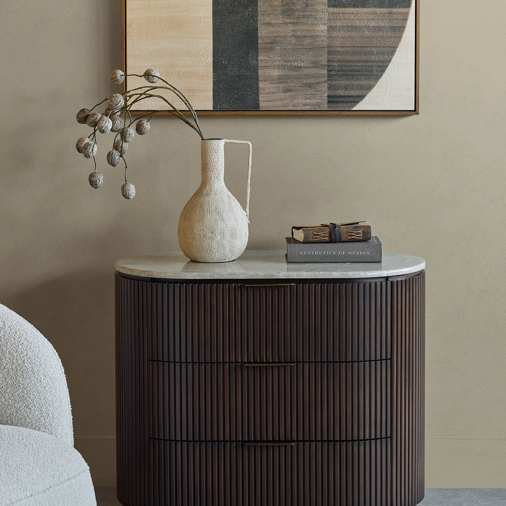 Dark wood chest with ribbed texture, styled in a modern room with art and decor.
