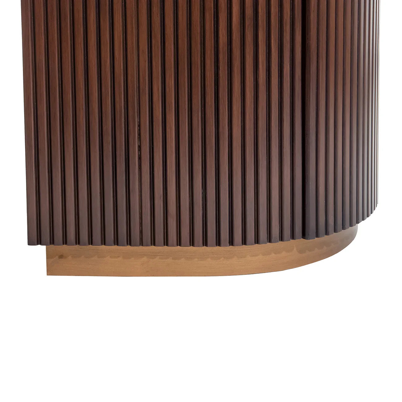 Dark wood desk corner with vertical grooves and light wood base.