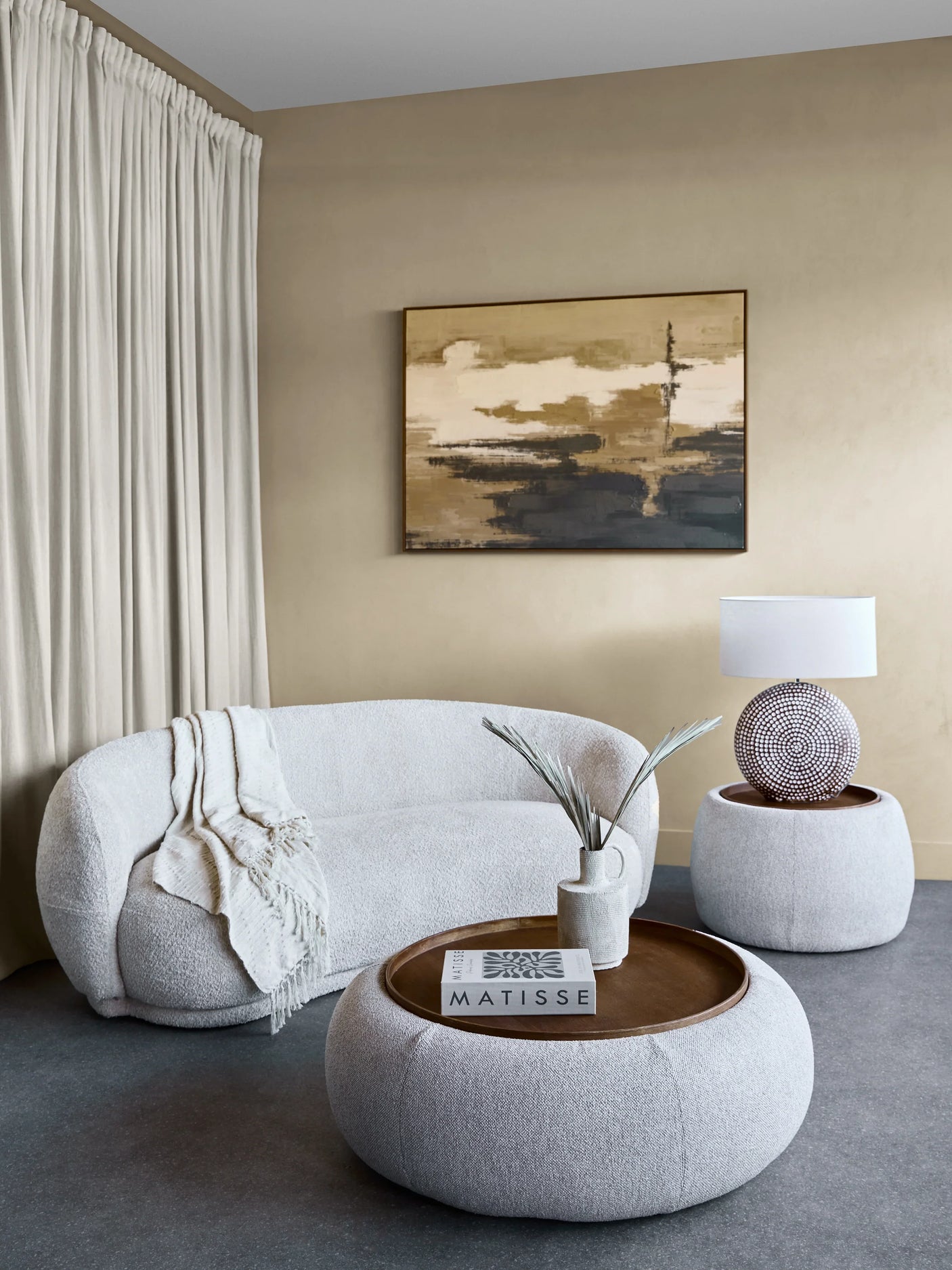 Oatmeal ottoman with wooden tray in modern living room setting.
