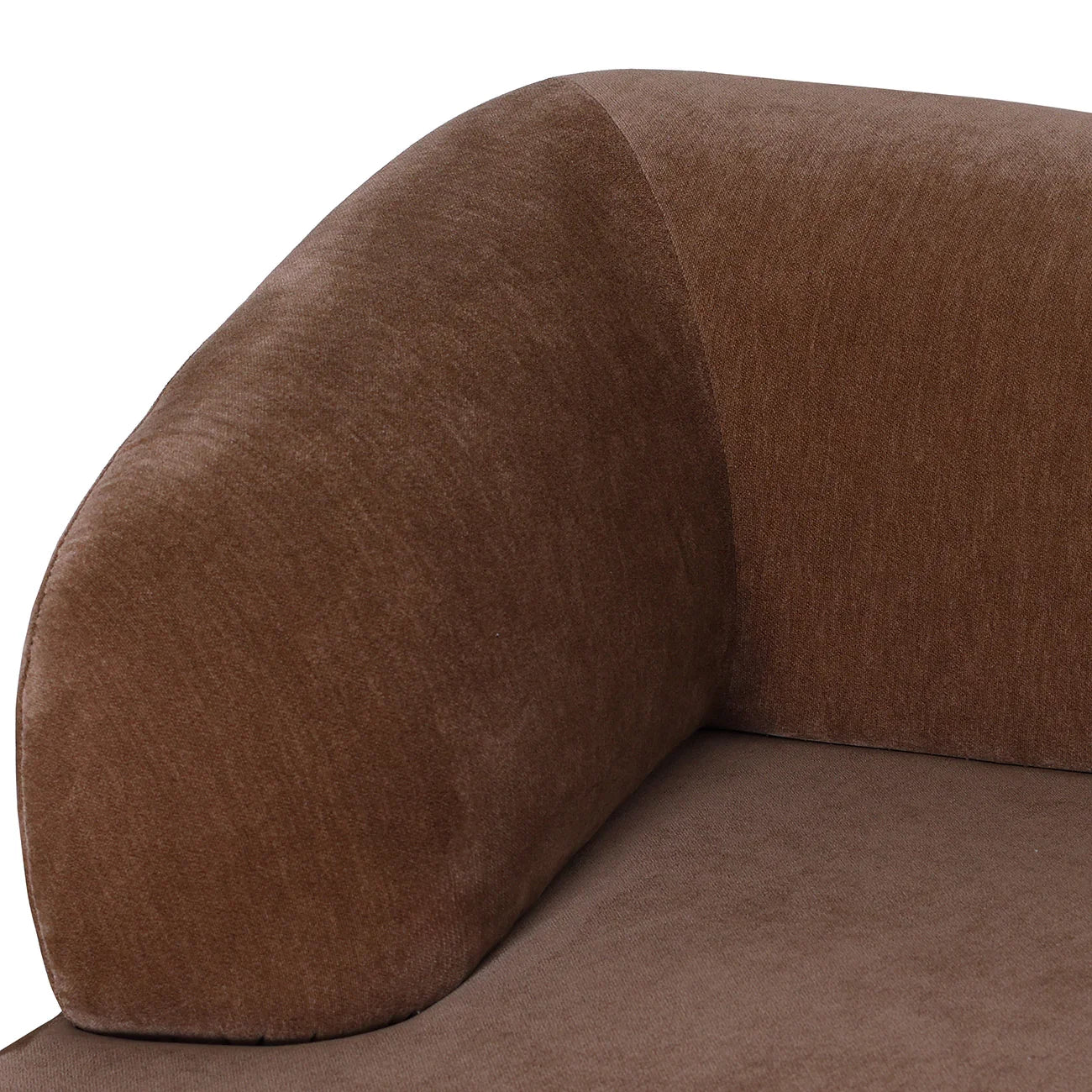 Mocha velvet sofa corner with a smooth, rounded armrest design.