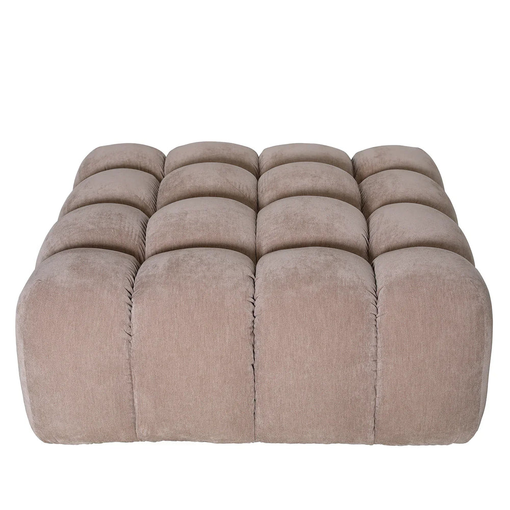 Beige tufted pouf with a soft, plush texture.