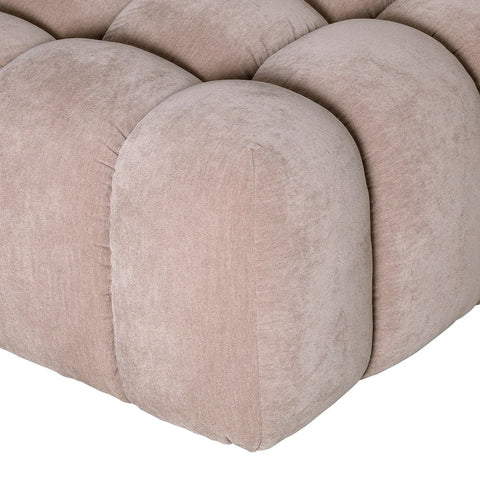 Beige pouf with tufted upholstery detail.